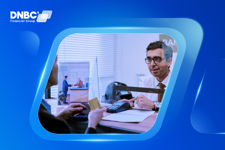 In-Person Bank Transfer with Assistance A bank teller helping a customer transfer funds between savings and checking accounts